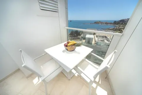 Balcony with a dining table and sea view. - image 13