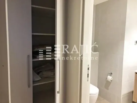 View of the bathroom and a built-in closet with open doors. - image 13