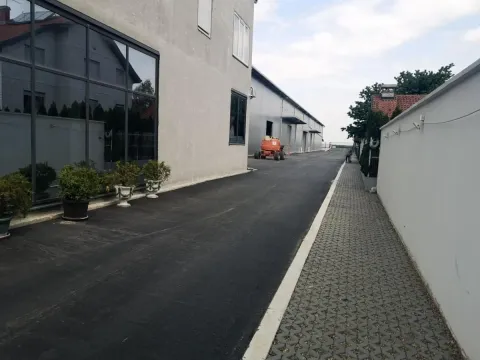 Asphalted courtyard and driveway next to the commercial building. - image 12