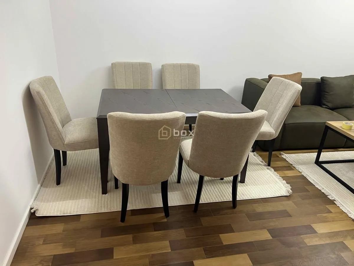 Dining table with chairs as part of the living room.