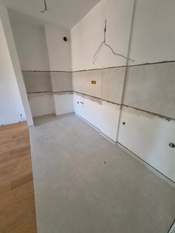 Unfurnished room under renovation with walls prepared for work.