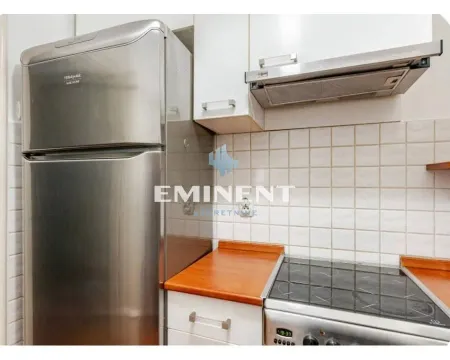 Small kitchen with a refrigerator, stove, and upper cabinets. - image 16