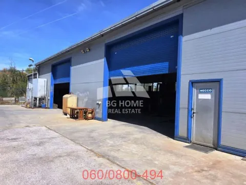 Exterior view of a commercial building with roller doors and an entrance door. - image 5
