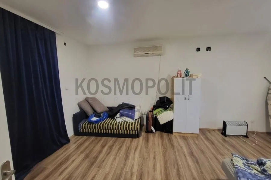 Small bedroom with a bed and a wardrobe.
