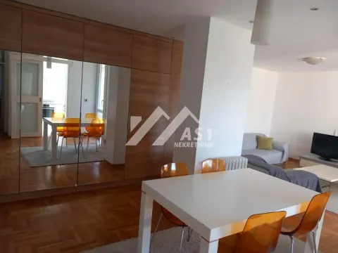 Living room with a dining area and a built-in wardrobe with mirrored doors. - image 3