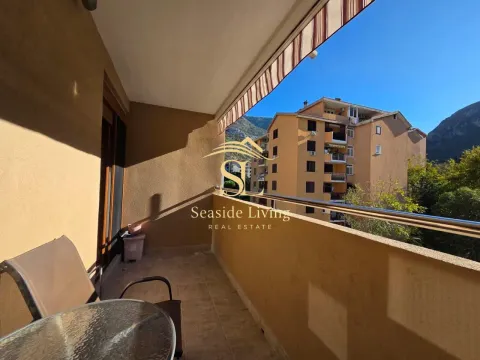 Furnished balcony with a view of neighboring buildings. - image 14