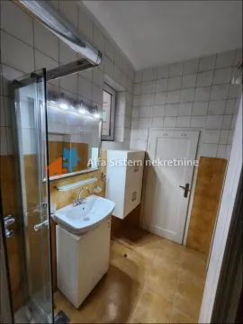 Bathroom with a shower cabin, washbasin, and white cabinets. - image 13