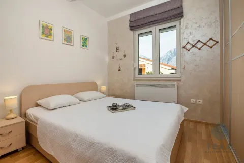 Bedroom with a double bed, bedside tables, and a window with a view of the surroundings. - image 11