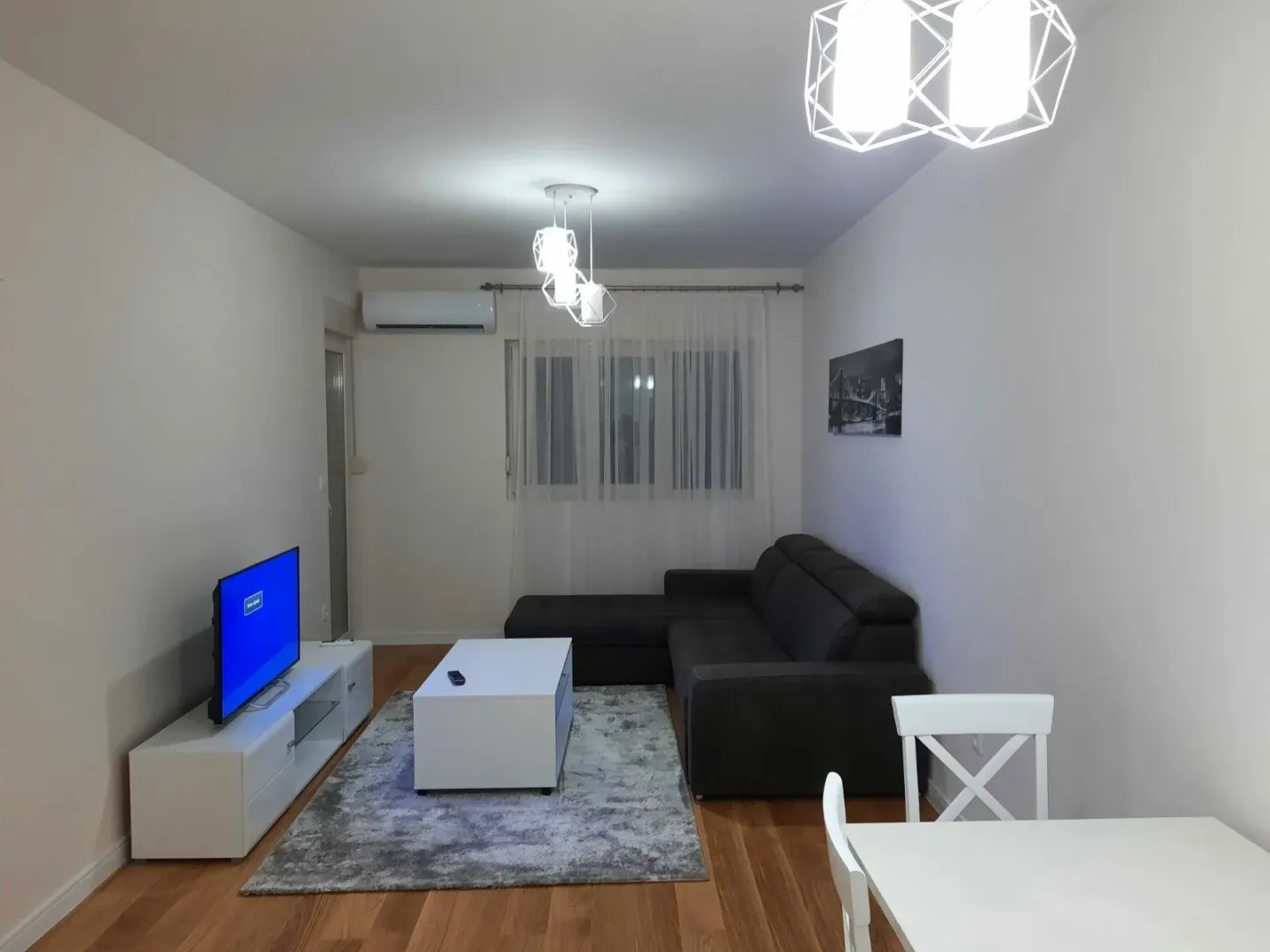 Bright living room with a corner sofa, coffee table, and TV.