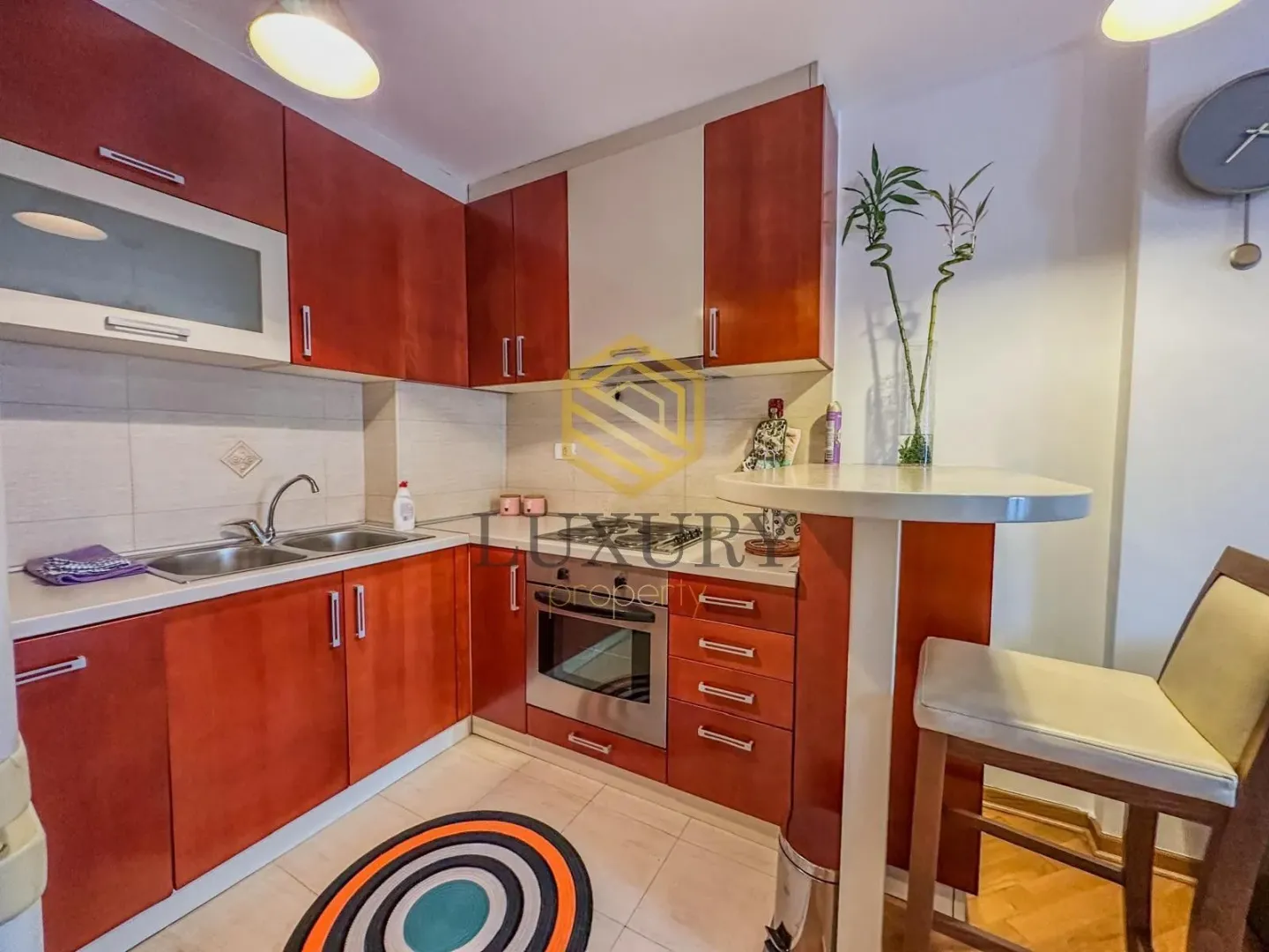 Smaller kitchen with wooden cabinets and a dining bar.