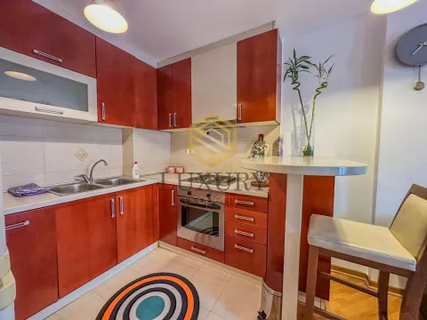 Smaller kitchen with wooden cabinets and a dining bar. - image 5