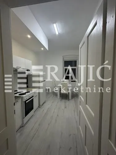 View from the hallway into the kitchen with dining area.