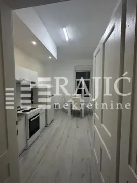 View from the hallway into the kitchen with dining area. - image 4
