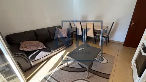 Living room with a sofa, coffee table, and dining table. - image 4