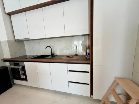 Modern white kitchen with wooden countertops. - image 7