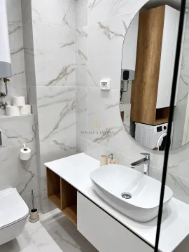 Modern bathroom with a washbasin, mirror, and built-in units. - image 11