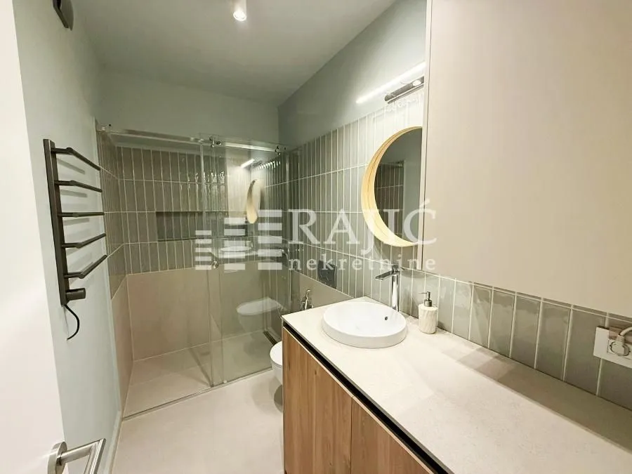 Modern bathroom with a sink and a shower cabin.