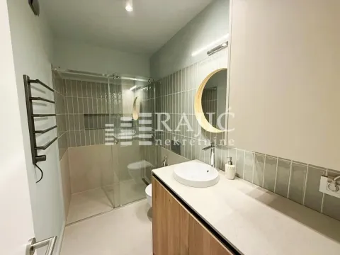 Modern bathroom with a sink and a shower cabin. - image 7