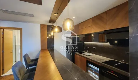 Modern kitchen with wooden elements, countertops, and a bar. - image 15