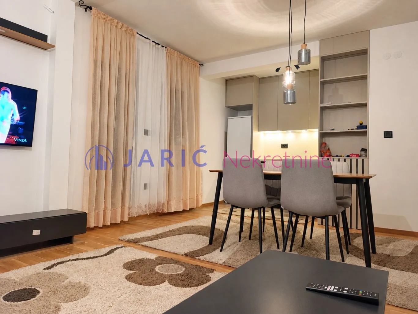Living room with dining area and kitchen in the background.