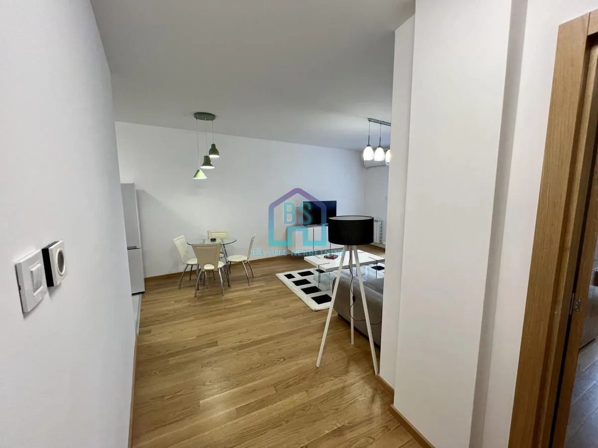 Living room with a dining area and parquet flooring.