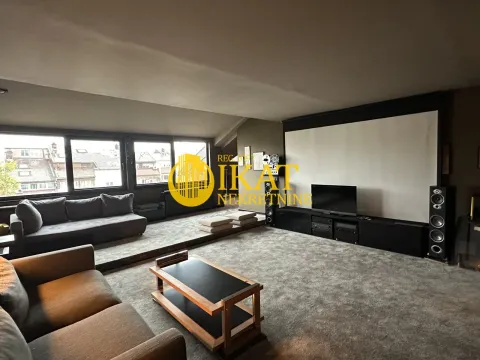 Spacious living room with seating furniture and a projection screen. - image 3