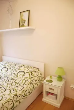 Furnished bedroom with a bed and a nightstand. - image 4