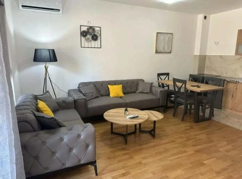 Living room with a sofa set, coffee table, and dining table.
