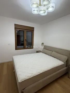 Furnished bedroom with a double bed and a window. - image 17