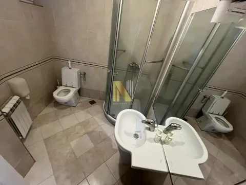 Spacious bathroom with a shower cabin, two washbasins, and a toilet. - image 31