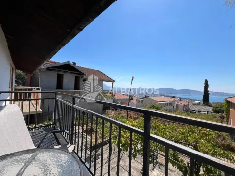View from the covered balcony towards the sea and surrounding buildings. - image 12