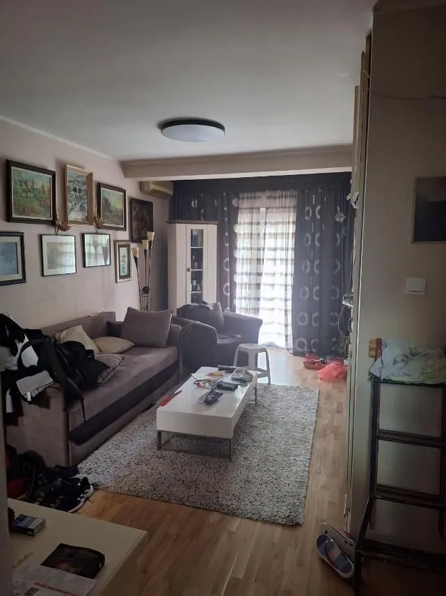 Living room with a sofa set, coffee table, and area rug.
