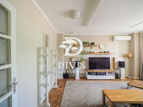 Living room with TV, shelves, and audio equipment. - image 3