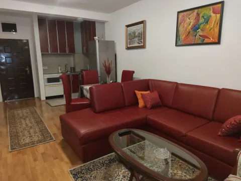 Living room with a red sectional sofa and kitchen. - image 25