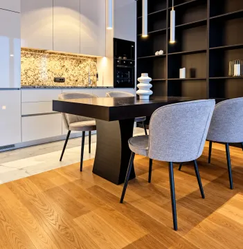 Modern kitchen with a dining table and grey chairs. - image 7