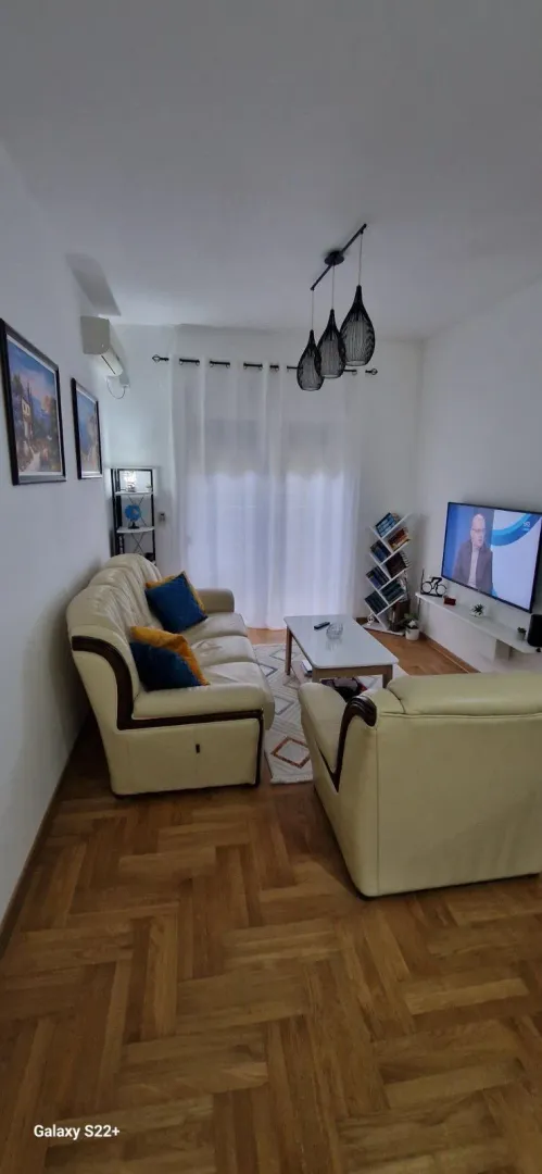 Living room with a sofa set, coffee table, and television.