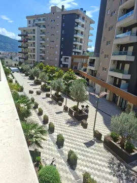 View from the terrace onto the paved courtyard between residential buildings. - image 3