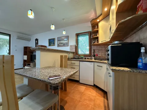 Fully equipped kitchen with a dining area and countertop space. - image 15