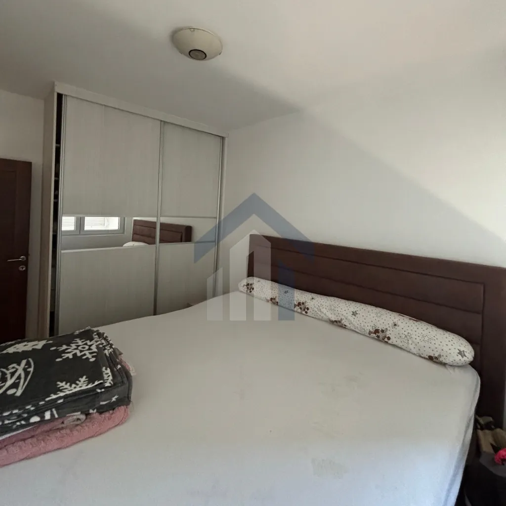 Bedroom with a double bed and a fitted wardrobe.
