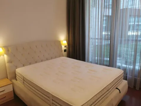 Bright bedroom featuring a large double bed and nightstands. - image 9