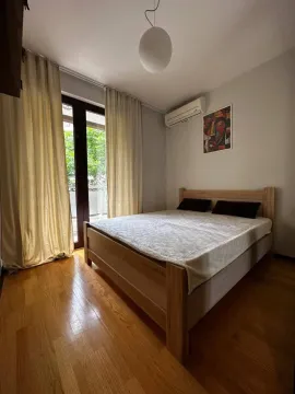 Spavaća soba sa bračnim krevetom, drvenim podom i izlazom na terasu. - image 5