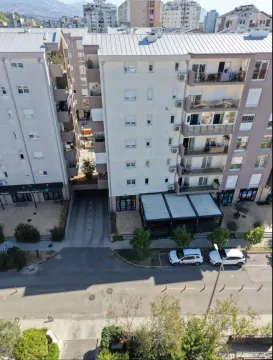 Aerial view of the residential building facade and the street in front of the entrance. - image 9