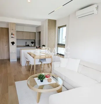 Living room with dining area and kitchen in bright tones. - image 5
