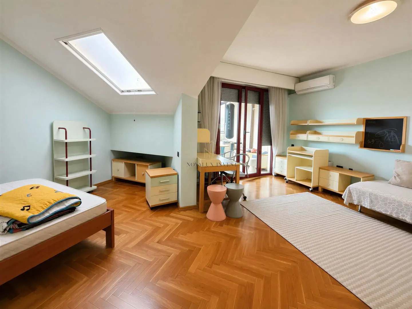 Children's bedroom with two beds, a desk, and access to the terrace.