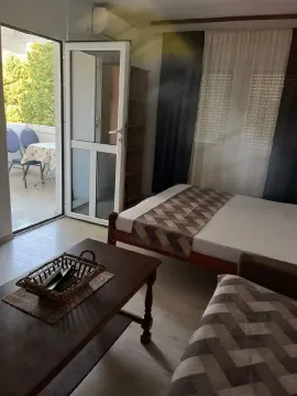 Living room with a bed and access to the terrace. - image 4