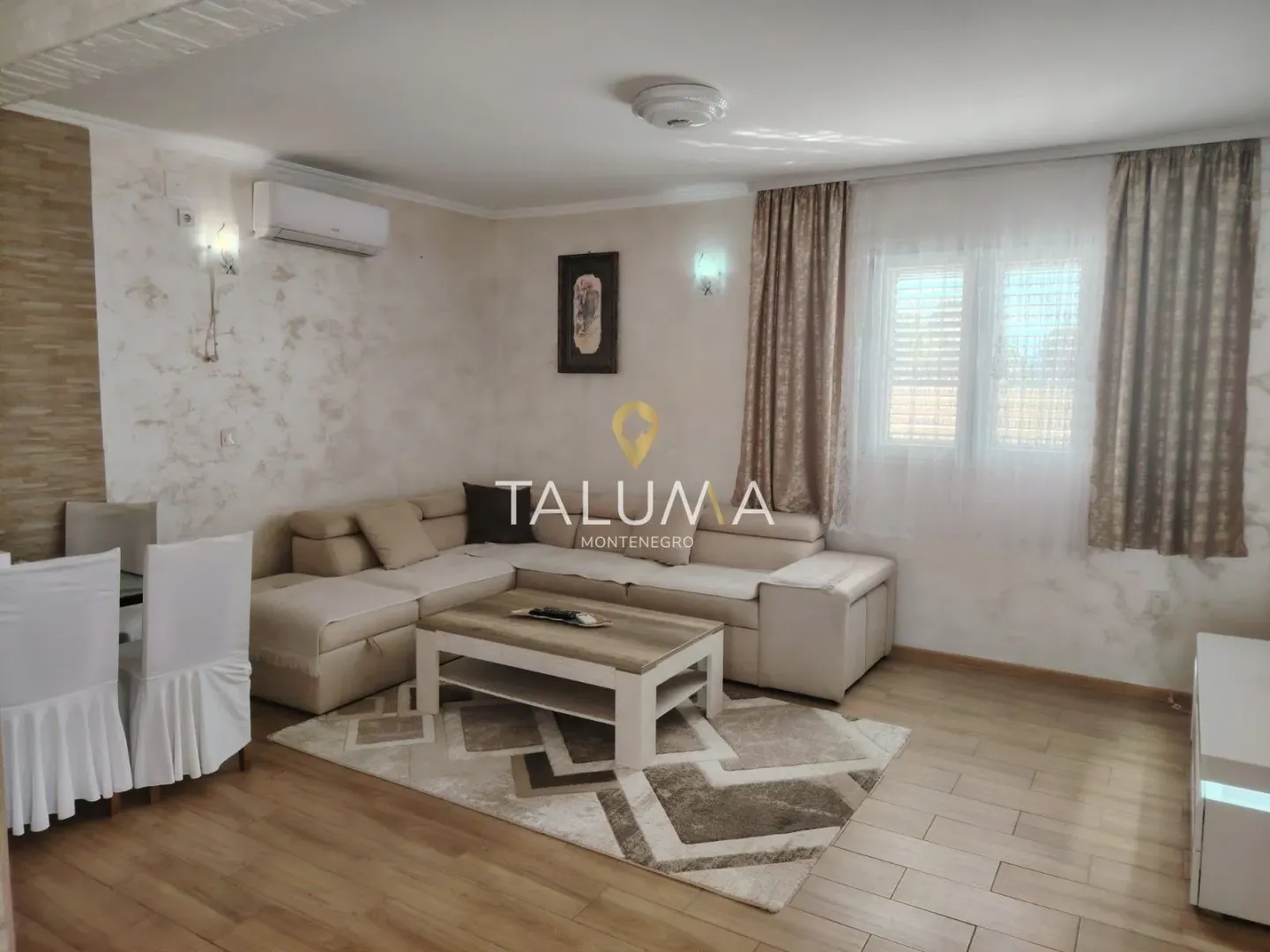 Living room with a corner sofa, coffee table, and dining table.
