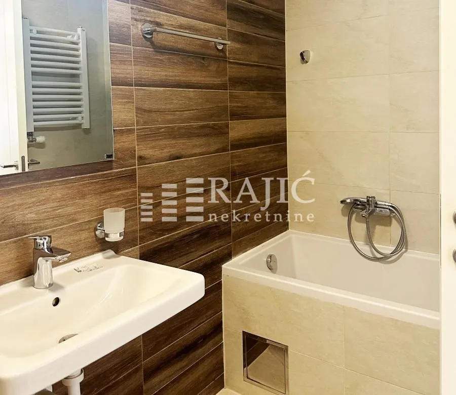 Modern bathroom with a sink and bathtub.