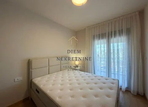 Bright bedroom with a double bed and balcony access. - image 14