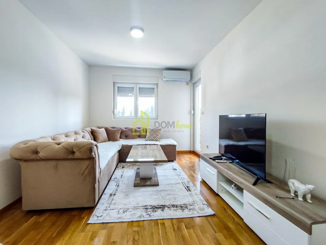 Living room with a sectional sofa, coffee table, and TV.