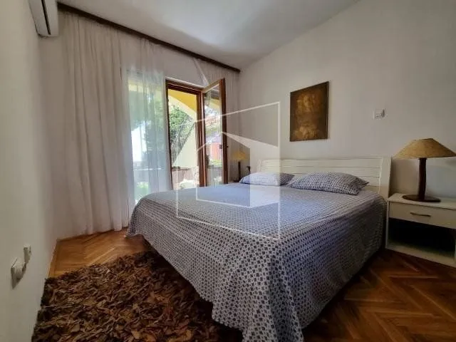 Bedroom with a double bed, nightstand, and access to the terrace.